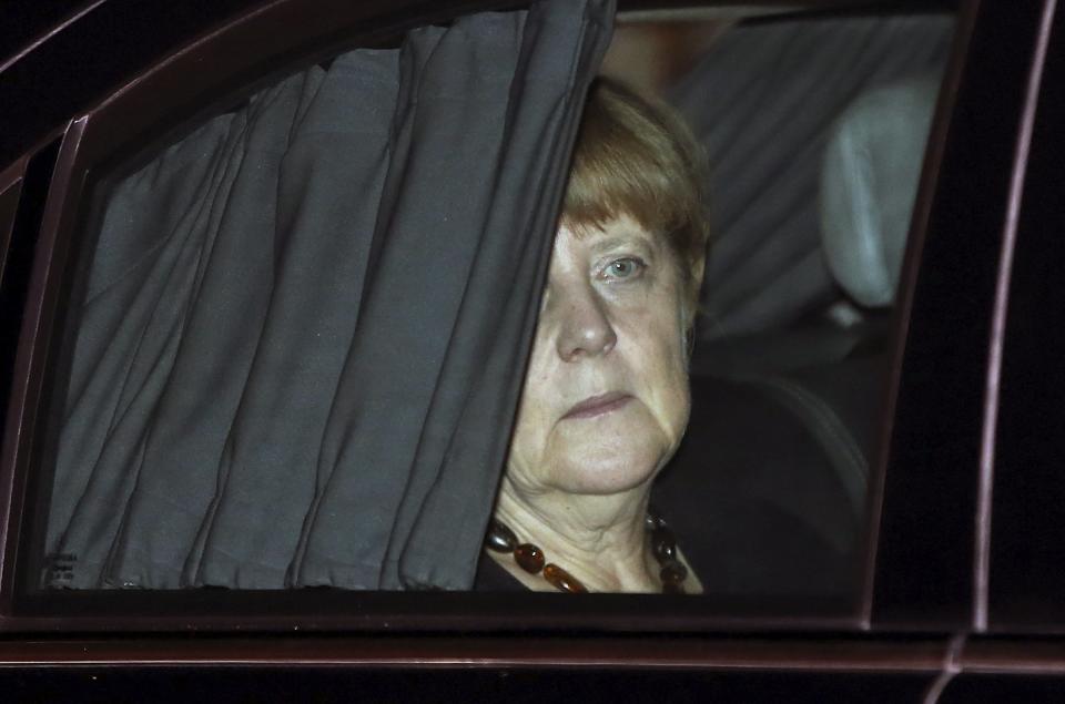German Chancellor Merkel sits in her car after her arrival at the airport in New Delhi