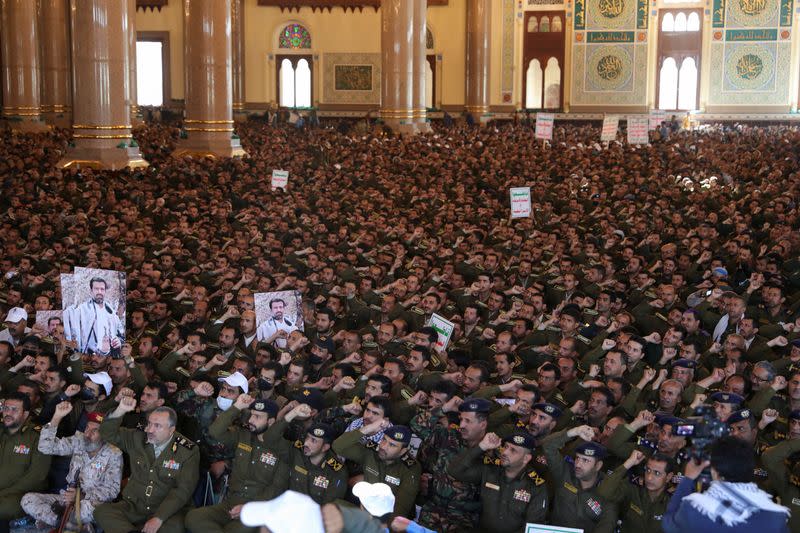 Police officers and cadets chant slogans as the Houthi leader Abdul-Malik al-Houthi delivers a speech via a video link in Sanaa