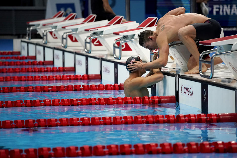CORRECTS TO RYAN MURPHY NOT JAMES GUY - Caeleb Dressel, of the United States, left, talks with teammate Ryan Murphy after they finished fifth in the mixed 4x100-meter medley relay at the 2020 Summer Olympics, Saturday, July 31, 2021, in Tokyo, Japan. (AP Photo/David Goldman)