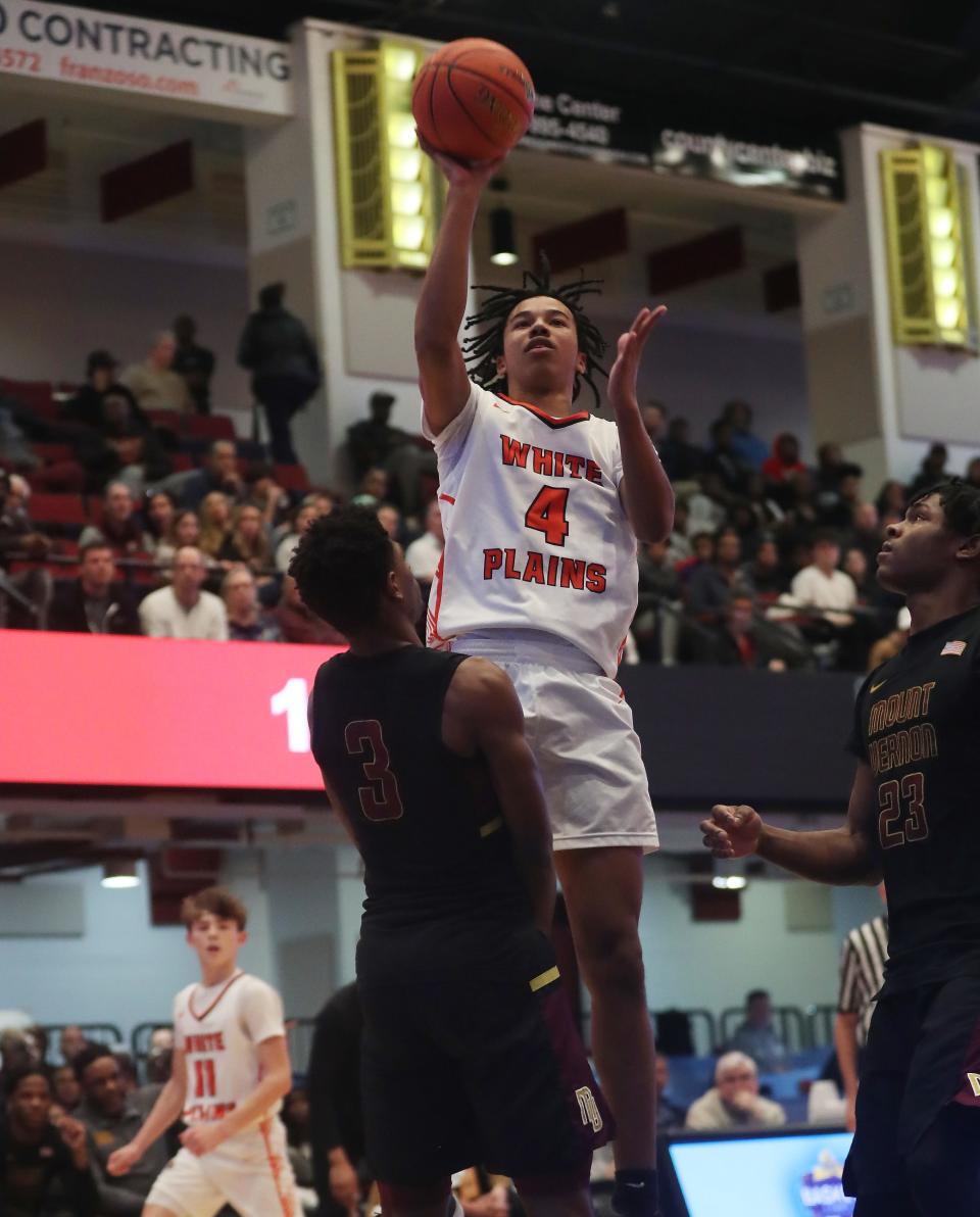 White Plains Logan McCormack (4) puts up a shot against Mt. Vernon during the Section 1 Class AAA semifinal at the Westchester County Center in White Plains Feb. 28, 2024.