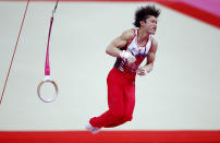 Kohei Uchimura of Japan dismounts after competing in the rings at the men's gymnastics qualification in the North Greenwich Arena during the London 2012 Olympic Games July 28, 2012. REUTERS/Brian Snyder (BRITAIN - Tags: SPORT OLYMPICS SPORT GYMNASTICS) 