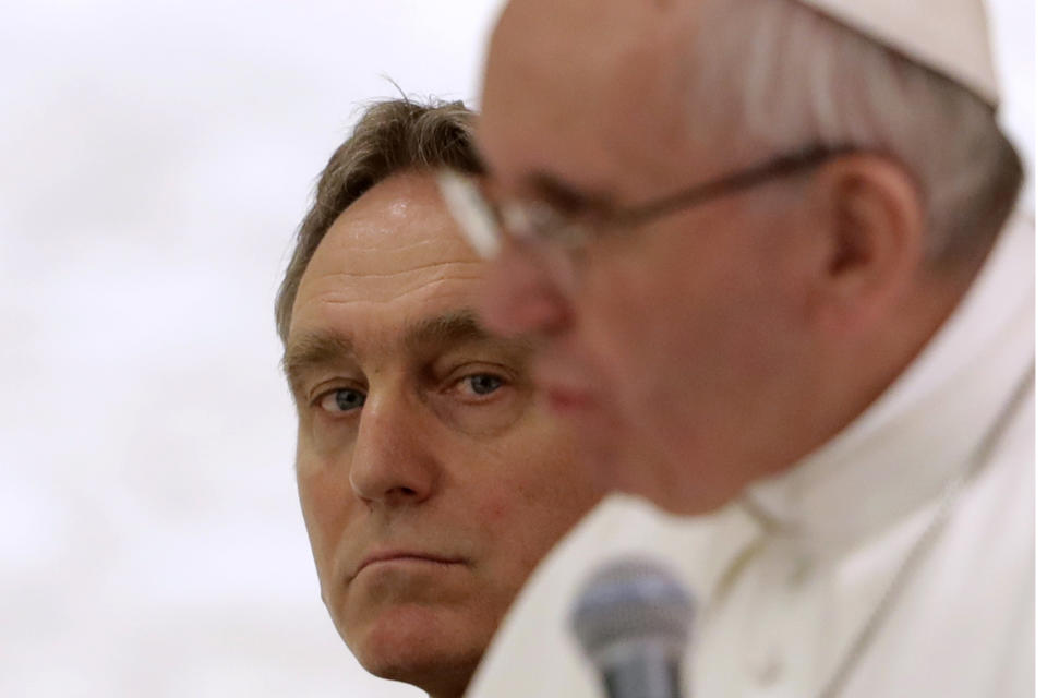 FILE - Archbishop Georg Gaenswein looks at Pope Francis delivering his message during an audience at the Paul VI Hall, at the Vatican, on Feb. 4, 2017. Pope Francis met on Monday, Jan. 9, 2023, with Archbishop Gaenswein, the longtime secretary of Pope Benedict XVI who was a key figure in his recent funeral but who has raised eyebrows with an extraordinary memoir in which he settles old scores and reveals palace intrigue. (AP Photo/Andrew Medichini, File)