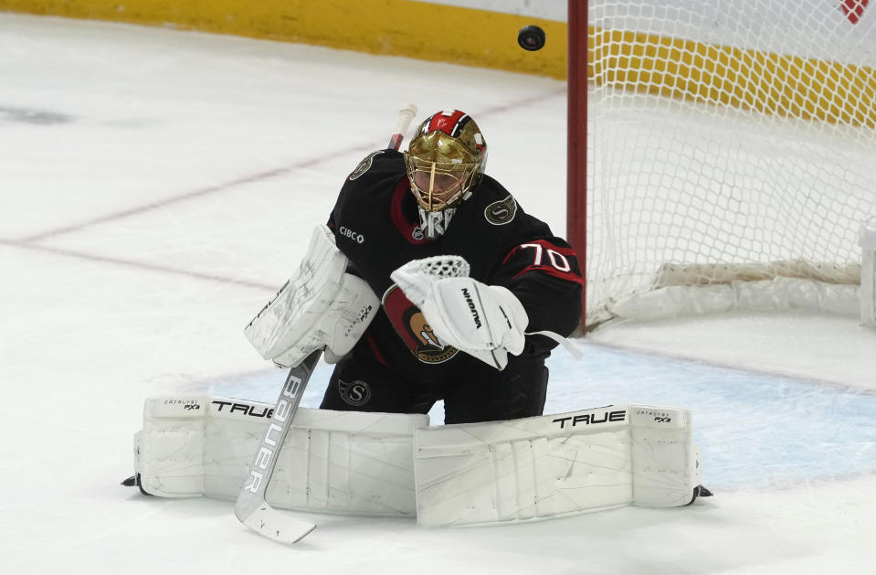 Ottawa Senators goaltender Joonas Korpisalo loses sight of the puck as it sails into the net on a deflection during first-period NHL hockey game action against the Montreal Canadiens, Thursday, Jan. 18, 2024, in Ottawa, Ontario. (Adrian Wyld/The Canadian Press via AP)