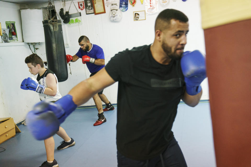 Arab boxers from right, Nashat el Jamal, and Ahmed Abu Abdun, work out with Jewish youth Dominique Rudyakov, 12, at the Maccabi Lod Boxing Club in the mixed Arab-Jewish town of Lod, central Israel, Wednesday, May 26, 2021. Club coach Yaacov Wallach said he heard from both his Arab and Jewish boxers everyday during the recent clashes when the club was closed to see if everything was ok. "This club is open to everyone," said Wallach. "Here we are like family." (AP Photo/David Goldman)