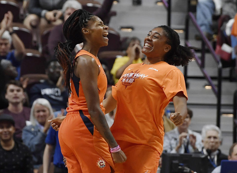 Connecticut Sun's Bria Holmes and teammate Morgan Tuck celebrate during the second half of Game 2 of a WNBA basketball playoff game, Thursday, Sept. 19, 2019, in Uncasville, Conn. (AP Photo/Jessica Hill)