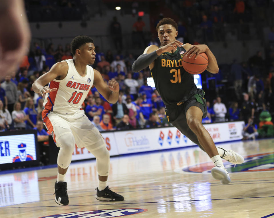 Baylor guard MaCio Teague (31) dribbles past Florida guard Noah Locke (10) during the second half of an NCAA college basketball game Saturday, Jan. 25, 2020, in Gainesville, Fla. (AP Photo/Matt Stamey)