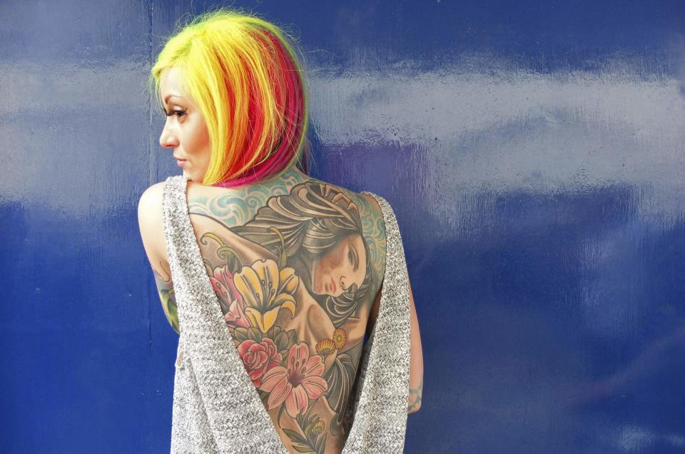 �Helen Taylor from Stoke-upon-Trent wears a backless top to show off her tattoos (Reuters)
