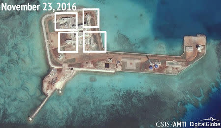 A satellite image shows what CSIS Asia Maritime Transparency Initiative says appears to be anti-aircraft guns and what are likely to be close-in weapons systems (CIWS) on the artificial island Hughes Reef in the South China Sea in this image released on December 13, 2016. CSIS Asia Maritime Transparency Initiative/DigitalGlobe/Handout via REUTERS