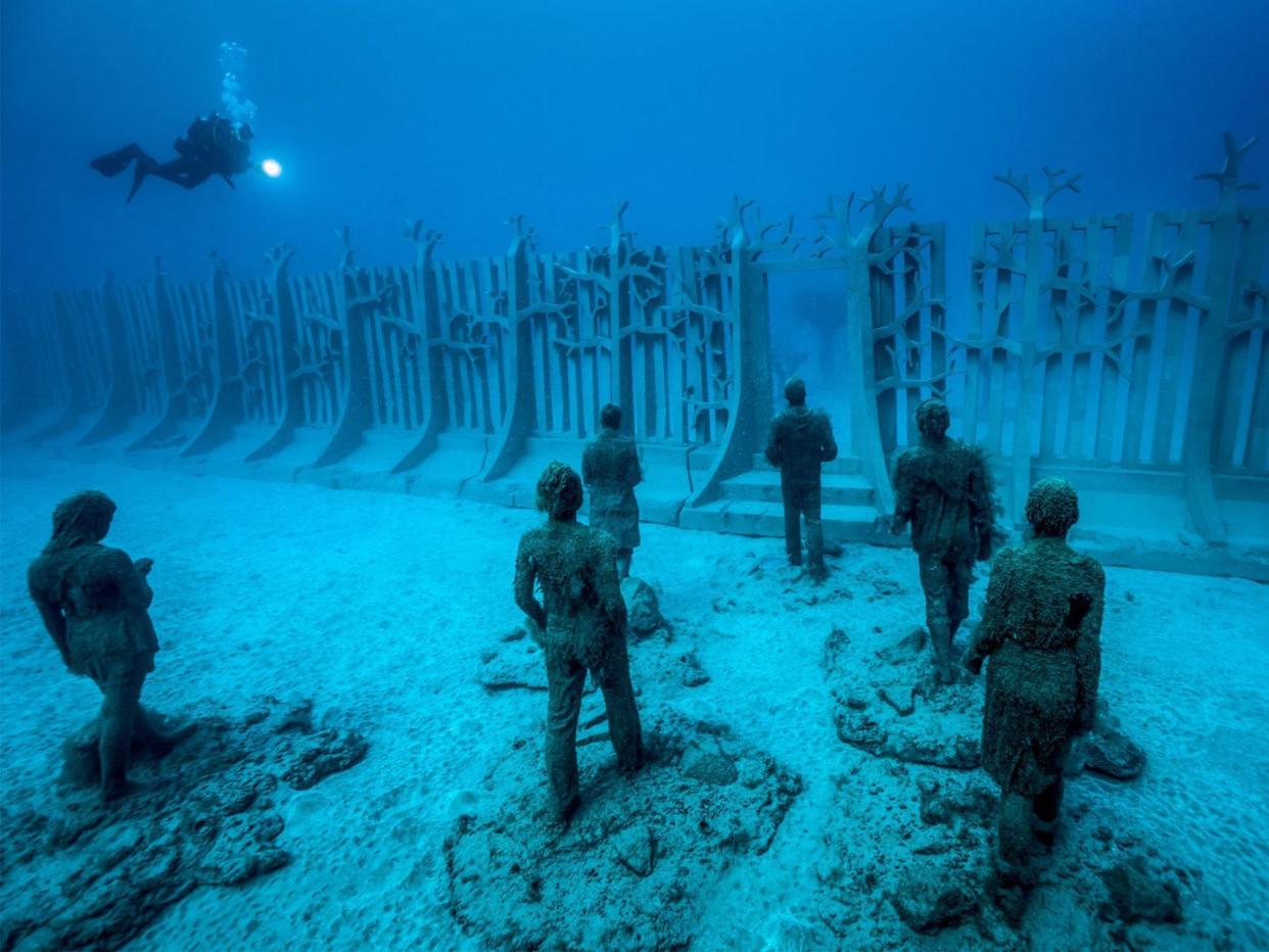 One of the new installations, Crossing the Rubicon, features 35 figures walking towards a gateway in a 30m-long, 100-tonne wall. The work is illustrative of the effects of climate change, and humankind's tendency to ignore responsibility towards it: All photos by Jason deCaires Taylor