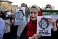 Supporters of Iranian president-elect Ebrahim Raisi celebrate after he won the presidential election in Tehran, Iran, Saturday, June 19, 2021. Initial results released Saturday propelled Raisi, a protege of the country's supreme leader, into Tehran’s highest civilian position. The vote appeared to see the lowest turnout in the Islamic Republic’s history. (AP Photo/Ebrahim Noroozi)