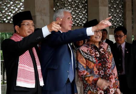 US Vice President Mike Pence accompanied by Chief Imam Nasaruddin Umar (L) and Chairman of the Istiqlal Mosque Management Executive Board, Muhammad Muzammil Basyuni (R) duirng his visit to the Istiqlal Mosque in Jakarta, Indonesia April 20, 2017. REUTERS/Adi Weda/Pool