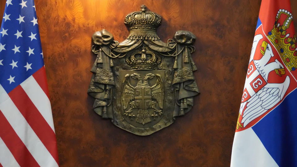 A Serbian coat-of-arms is seen between US, left, and Serbian flags during the meeting of U.S. State Department Counselor Derek Chollet and Serbian Prime Minister Ana Brnabic in Belgrade, Serbia, Thursday, Jan. 12, 2023. The United States supports longstanding European Union efforts to mediate the relations between Serbia and Kosovo, a former Serbian province that declared independence in 2008. Belgrade does not recognize Kosovo as a sovereign state. (AP Photo/Darko Vojinovic)