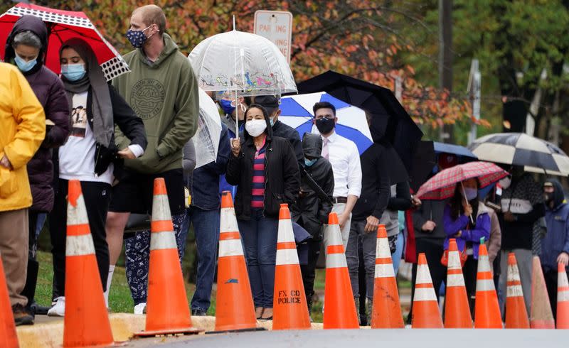 Early voters line up in the rain in Annandale, Virginia