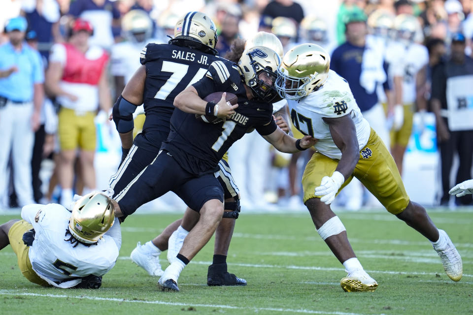 Purdue quarterback Hudson Card (1) is sacked by Notre Dame defensive lineman Boubacar Traore (5) and defensive lineman Jason Onye (47) during the second half of an NCAA college football game in West Lafayette, Ind., Saturday, Sept. 14, 2024. (AP Photo/Michael Conroy)