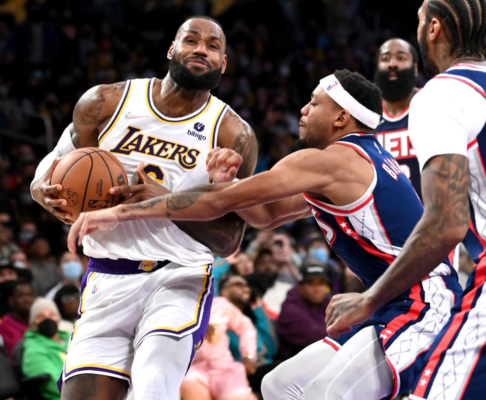 LOS ANGELES, CA - DECEMBER 25: LeBron James #6 of the Los Angeles Lakers is defended by Bruce Brown #1 of the Brooklyn Nets as he drives to the basket in the second half of the game at Crypto.com Arena on December 25, 2021 in Los Angeles, California. NOTE TO USER: User expressly acknowledges and agrees that, by downloading and/or using this Photograph, user is consenting to the terms and conditions of the Getty Images License Agreement.   (Photo by Jayne Kamin-Oncea/Getty Images)