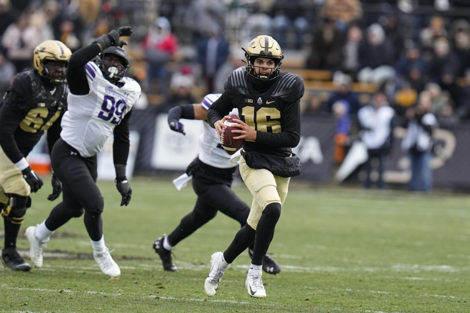 Purdue quarterback Aidan O'Connell (16) scrambles against Northwestern during the second half of an NCAA college football game in West Lafayette, Ind., Saturday, Nov. 19, 2022. Purdue defeated Northwestern 17-9. (AP Photo/Michael Conroy)