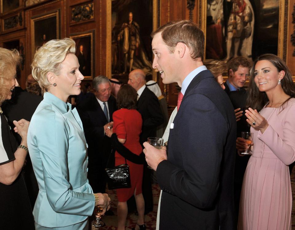 Britain's Duke and Duchess of Cambridge, right, talk to Charlene, Princess of Monaco before a reception in the Waterloo Chamber, before the Queen's Monarchs Jubilee lunch at Windsor Castle Friday May 18, 2012. Critics are aghast at the choice of some guests for the lunch _ among them a king whose Gulf nation has been engaged in a brutal crackdown on political dissent. The list for Friday's lunch _ sent on the advice of British diplomats _ includes Bahrain's King Hamad bin Isa Al Khalifa. Swaziland's King Mswati III _ accused of living in luxury while his people go hungry _ is also invited. (AP Photo/ John Stillwell, Pool)