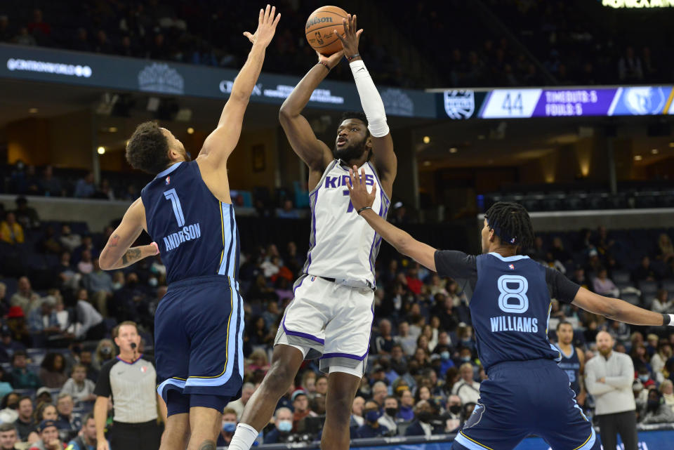 Sacramento Kings forward Chimezie Metu (7) shoots against Memphis Grizzlies forwards Kyle Anderson (1) and Maurice Harkless (8) in the first half of an NBA basketball game Sunday, Nov. 28, 2021, in Memphis, Tenn. (AP Photo/Brandon Dill)