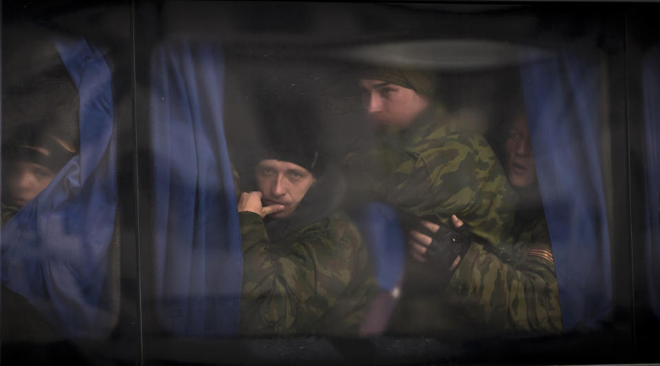 Crimean self defense units volunteers overcrowd a bus prior to a swearing in ceremony in Simferopol, Ukraine, Saturday, March 8, 2014. Ukraine lurched toward breakup Thursday as lawmakers in Crimea unanimously declared they wanted to join Russia and would put the decision to voters in 10 days. President Barack Obama condemned the move and the West answered with the first real sanctions against Russia. (AP Photo/Vadim Ghirda)