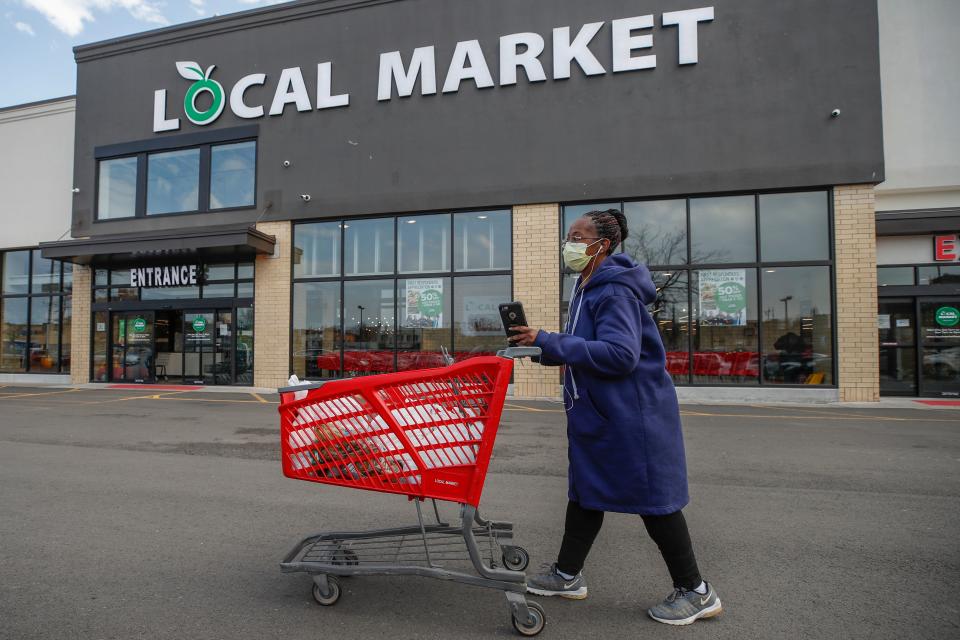 A woman leaves the Local Market Foods store after shopping for groceries in Chicago, Illinois, on April 8, 2020. (Photo by KAMIL KRZACZYNSKI / AFP) (Photo by KAMIL KRZACZYNSKI/AFP via Getty Images)