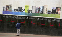 A man looks at a timeline of the life of the late Colombian author Gabriel Garcia Marquez on a wall at the Luis Angel Arango Library in downtown Bogota, Colombia, Thursday, April 17, 2014. The Nobel laureate died in Mexico City on Thursday. Garcia Marquez was among Latin America's most popular writers and widely considered the father of a literary style known as magic realism. (AP Photo/Ricardo Mazalan)