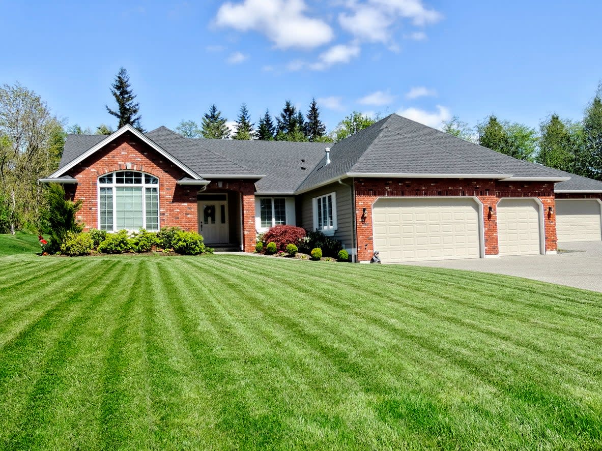 red-brick-house-with-a-green-freshly-mowed-lawn