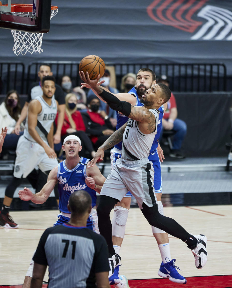 Portland Trail Blazers guard Damian Lillard (0) shoots over Los Angeles Lakers center Marc Gasol during the second half of an NBA basketball game in Portland, Ore., Friday, May 7, 2021. (AP Photo/Craig Mitchelldyer)