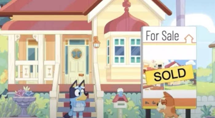 Animated character Bluey's house with a 'For Sale' sign changed to 'SOLD.'