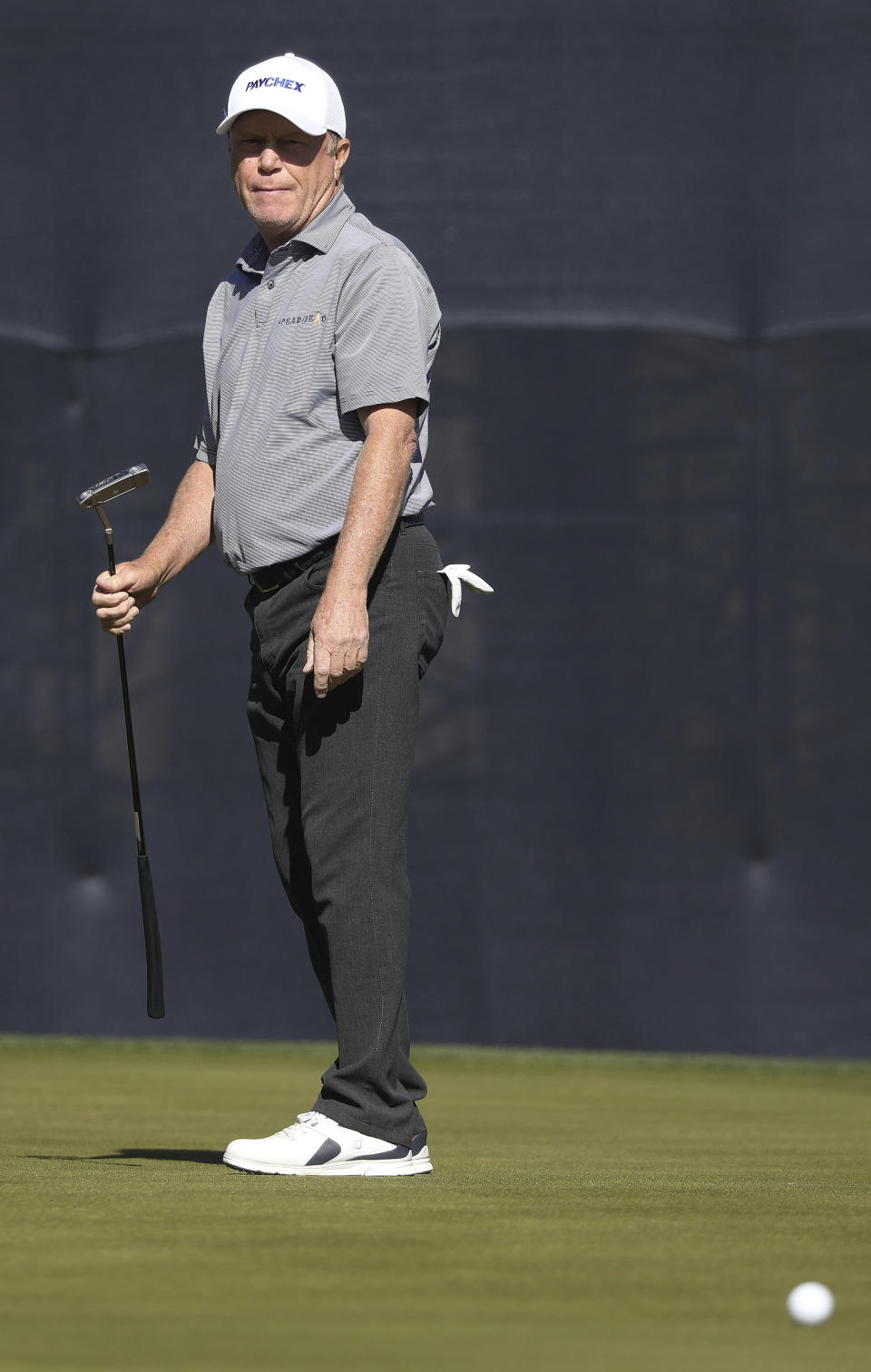 Jeff Sluman watches his putt on 18 loop around the cup during the Cologuard Classic golf tournament at Omni Tucson National Resort in Tucson, Ariz., Friday, Feb. 25, 2022. (Rick Wiley/Arizona Daily Star via AP)