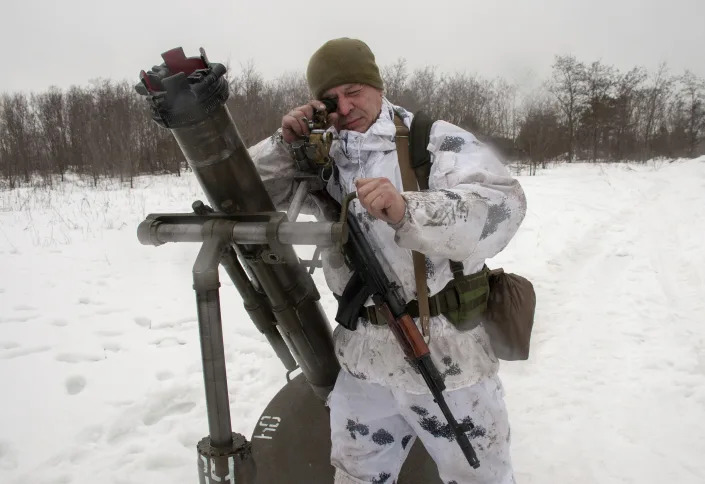 A Ukrainian soldier trains during military drills close to Kharkiv, Ukraine, Thursday, Feb. 10, 2022. Britain's top diplomat has urged Russia to take the path of diplomacy even as thousands of Russian troops engaged in sweeping maneuvers in Belarus as part of a military buildup near Ukraine. (AP Photo/Andrew Marienko)