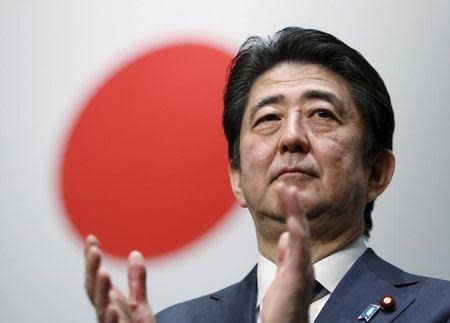 Japan's Prime Minister Shinzo Abe claps his hands during the ruling Liberal Democratic Party (LDP) annual convention in Tokyo, Japan, March 13, 2016. REUTERS/Yuya Shino