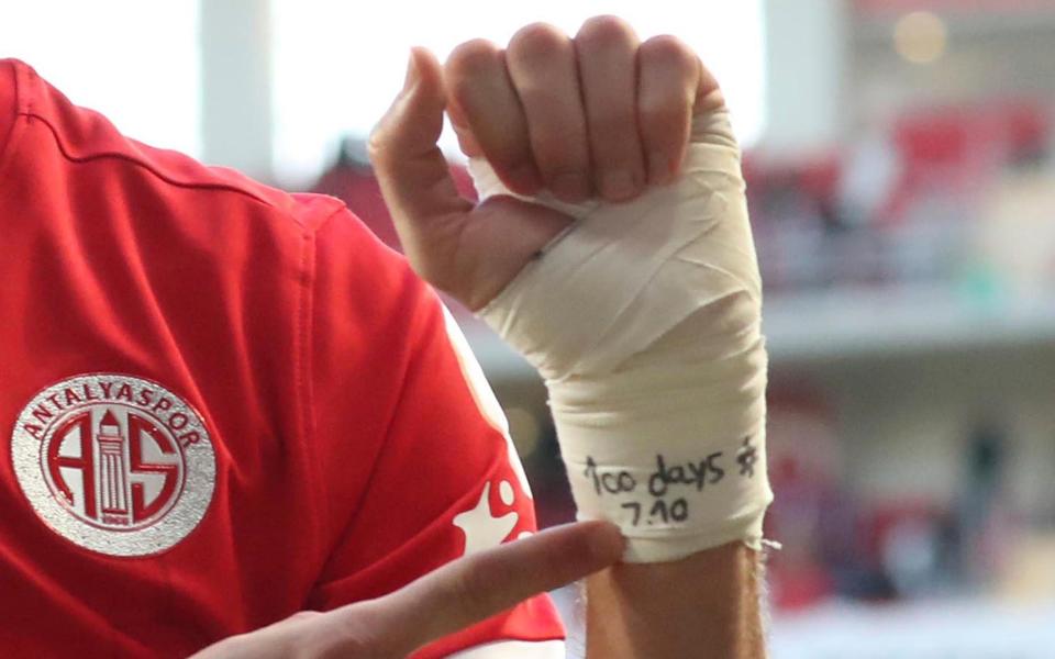 Antalyaspor's Sagiv Jehezkel points a message in his bandage that reads: "100 days. 7.10"