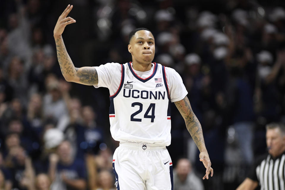 Connecticut's Jordan Hawkins (24) reacts after making a basket in the first half of an NCAA college basketball game against Oklahoma State, Thursday, Dec. 1, 2022, in Storrs, Conn. (AP Photo/Jessica Hill)