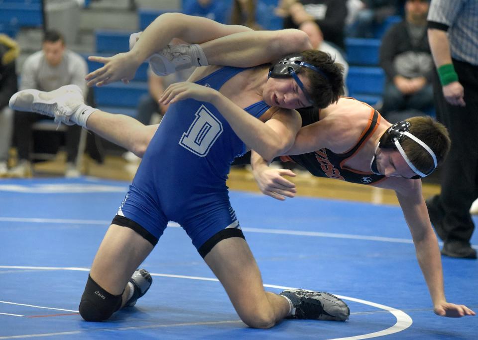 Senior Jacob Fenbert of Dundee goes onto escape from Calix Campbell of Hudson in the 175 pound match going onto for the pin in their league dual meet Wednesday, February 1, 2023 on senior night at Dundee High School.