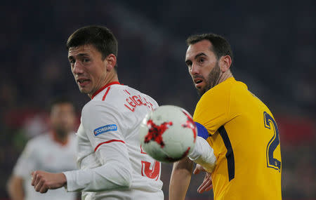 Soccer Football - Spanish King's Cup - Quarter Final Second Leg - Sevilla vs Atletico Madrid - Ramon Sanchez Pizjuan, Seville, Spain - January 23, 2018 Atletico Madrid's Diego Godin in action with Sevilla’s Clement Lenglet REUTERS/Jon Nazca