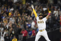 San Diego Padres' Fernando Tatis Jr. (23) celebrates after Jake Cronenworth (9) hit a two-run home run during the fifth inning of a baseball game against the Los Angeles Dodgers, Monday, June 21, 2021, in San Diego. (AP Photo/Denis Poroy)