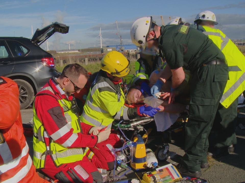 Medics attend to Richard Stephenson at the scene