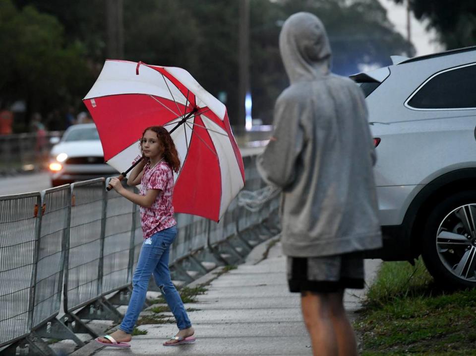 A young girl with a large umbrella looks hopefully at the parade route after the cancellation of the De Soto Parade was announced due to weather. Tiffany Tompkins/ttompkins@bradenton.com