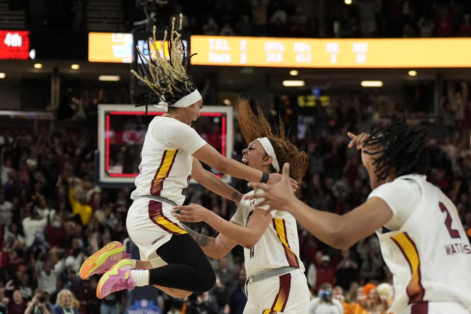 South Carolina center Kamilla Cardoso, middle, celebrates after scoring the game winning basket with guard Te-Hina Paopao, left, forward Ashlyn Watkins against Tennessee during the second half of an NCAA college basketball game at the Southeastern Conference women's tournament Saturday, March 9, 2024, in Greenville, S.C. (AP Photo/Chris Carlson)