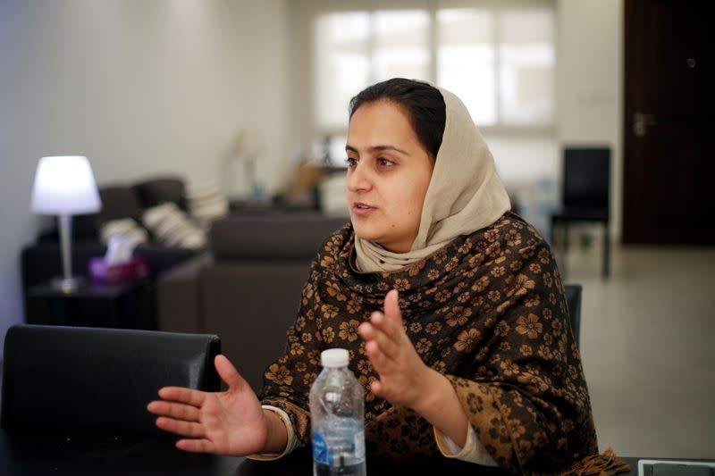 Afghan news anchor Beheshta Arghand speaks to her brother at a temporary residence compound in Doha