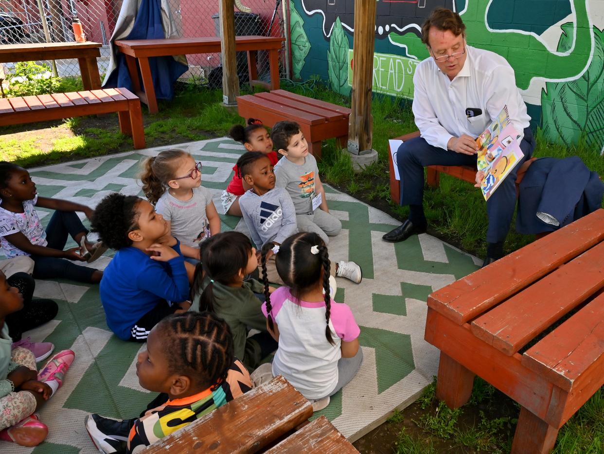 State Sen. Michael Moore reads a story to preschool students enrolled in the Worcester Head Start program during their field trip to the Regional Environment Council YouthGROW Farm on Tuesday.
