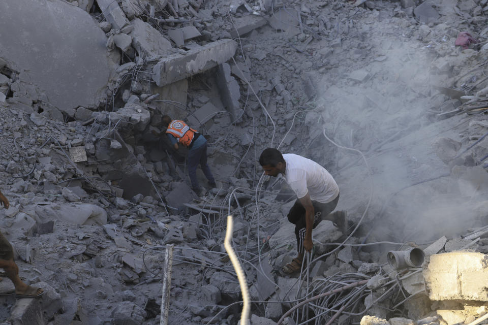 Palestinians search for bodies and survivors in the rubble of a residential building destroyed in an Israeli airstrike in Khan Younis, Gaza Strip, Wednesday, July 3, 2024. (AP Photo /Jehad Alshrafi)