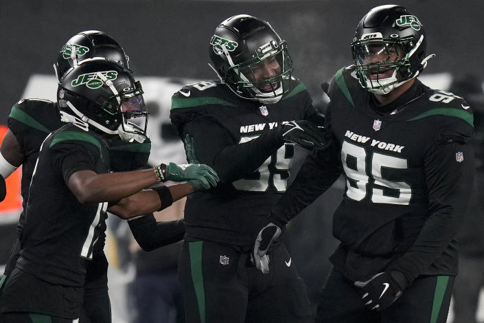 New York Jets defensive tackle Quinnen Williams (95) celebrates with teammates after forcing a fumble against the Jacksonville Jaguars during the first quarter of an NFL football game, Thursday, Dec. 22, 2022, in East Rutherford, N.J. (AP Photo/Seth Wenig)