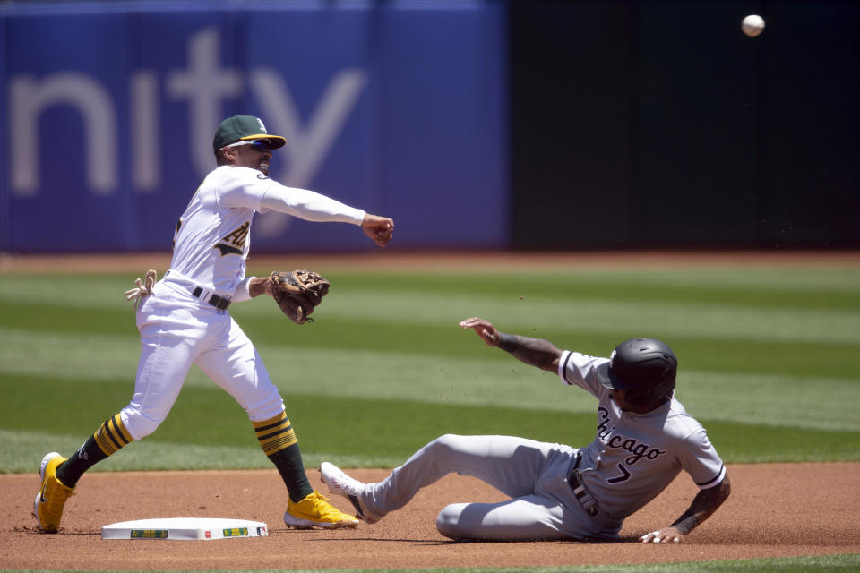 Oakland Athletics second baseman Tony Kemp (5) throws over Chicago White Sox's Tim Anderson (7) to complete a double play during the first inning of a baseball game, Saturday, July 1, 2023, in Oakland, Calif. Luis Robert Jr. was out at first base. (AP Photo/D. Ross Cameron)