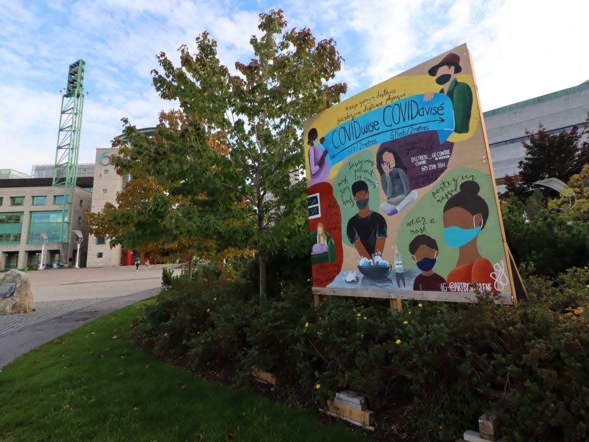 A sign outside Ottawa City Hall urges residents to wear a mask, wash their hands and obey COVID-19 physical distancing measures on Oct. 14, 2021. (Trevor Pritchard/CBC - image credit)