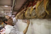 Italian ham is put on display in a deli in Rome, Thursday, Oct. 3, 2019. The U.S. had prepared for Wednesday's ruling and already drawn up lists of the dozens of goods it would put tariffs on. They include EU cheeses, olives, and whiskey, as well as planes, helicopters and aircraft parts in the case _ though the decision is likely to require fine-tuning of that list if the Trump administration agrees to go for the tariffs. (AP Photo/Alessandra Tarantino)