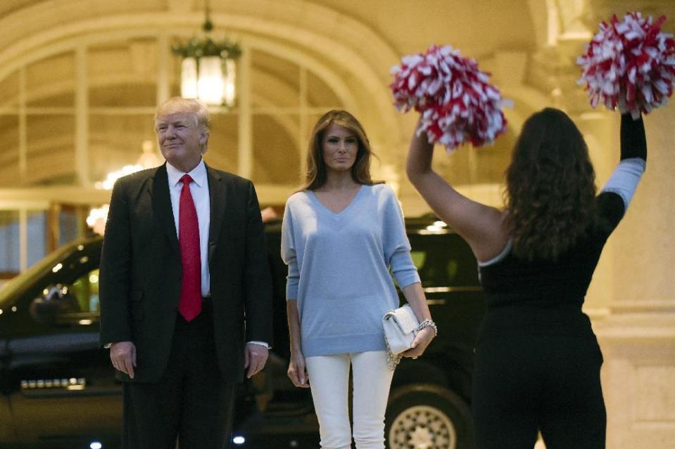 President Donald Trump and first lady Melania Trump watch the Palm Beach Central High School Band as they play for their arrival at Trump International Golf Club in West Palm Beach, Fla., Sunday, Feb. 5, 2017. The Trumps are attending a Super Bowl party at the club. (AP Photo/Susan Walsh)