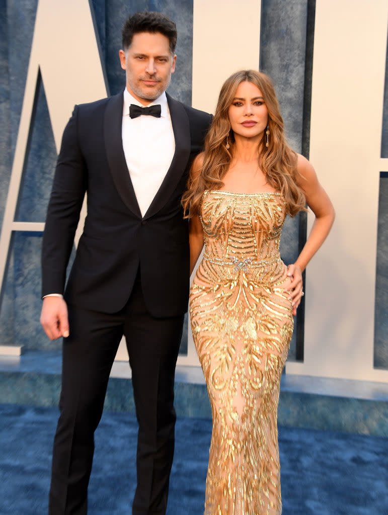 Joe Manganiello in a classic tuxedo and Sofia Vergara in an ornate, beaded gown pose together on a red carpet