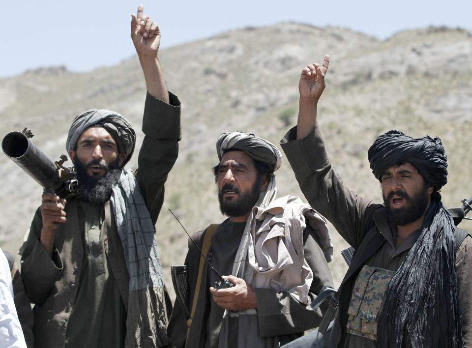 FILE - In this May 27, 2016 file photo, Taliban fighters react to a speech by their senior leader in the Shindand district of Herat province, Afghanistan. In a Thursday, March 28, 2019 report the Special Inspector General for Afghan Reconstruction, a U.S. watchdog, said that Afghanistan will remain dependent on international donors and foreign help even after a peace deal with the Taliban is reached. The report identified main high-risk areas including the reintegration of as many as 60,000 heavily armed Taliban fighters and their families back into Afghan society. (AP Photos/Allauddin Khan, File)