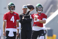 New York Jets quarterback Zach Wilson (2) looks to pass as James Morgan (4) and quarterbacks coach Rob Calabrese look on during practice at the team's NFL football training facility, Saturday, July. 31, 2021, in Florham Park, N.J. (AP Photo/Rich Schultz)